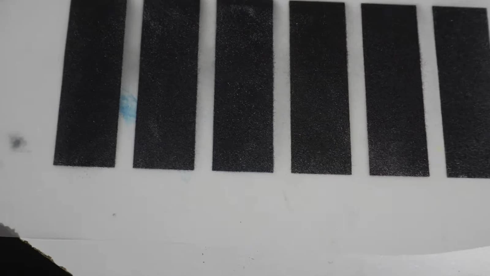 Visible black DTF powder residue before heat pressing